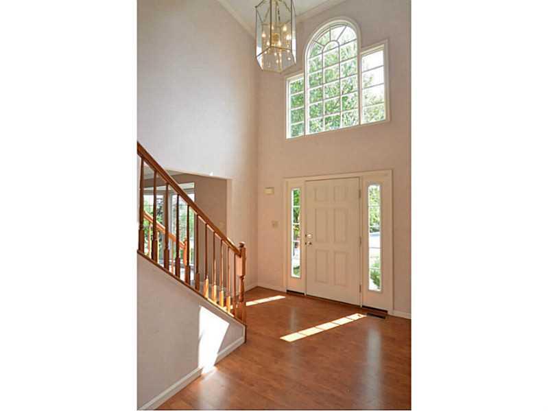 Entry/Foyer. The open two story offers a large palladium window and laminate flooring.