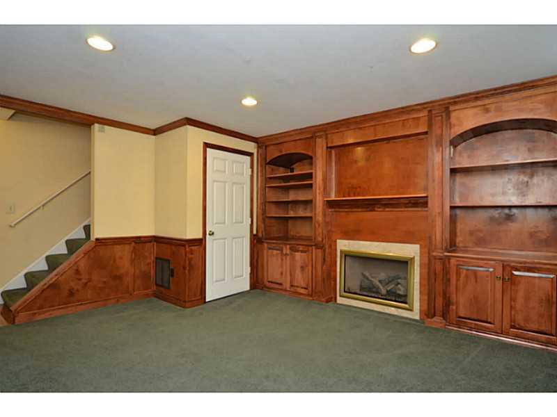 342 Indian Ridge Drive Coraopolis, PA 15108 - Photo 18 of 25 Basement/Game Room. The finished basement includes a gas fireplace with built-in shelving.