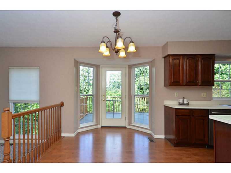 Kitchen. The large eat-in kitchen includes laminate flooring and a bay window with door that leads to the deck.