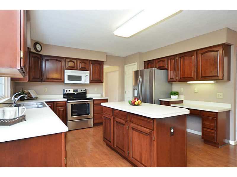 Kitchen. The kitchen offers cherry cabinets and large center island.