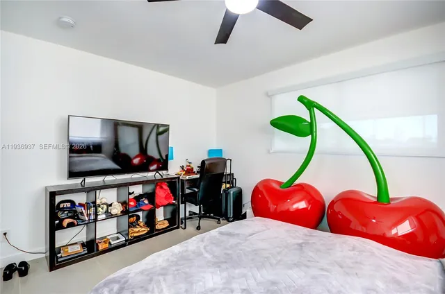 a bedroom with bed and tv