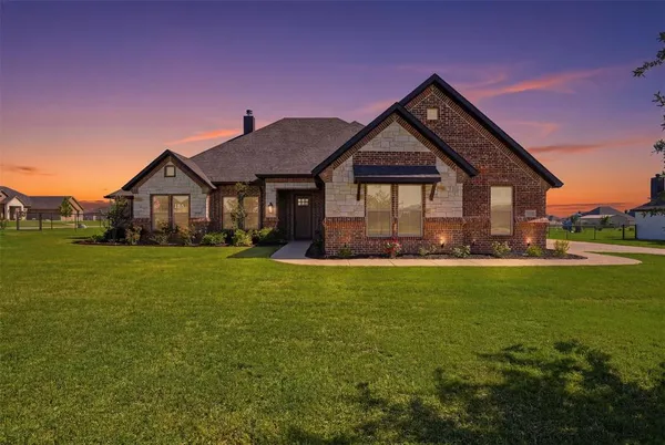 a front view of house with garden and patio