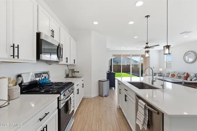 a living room with furniture a table and a chandelier