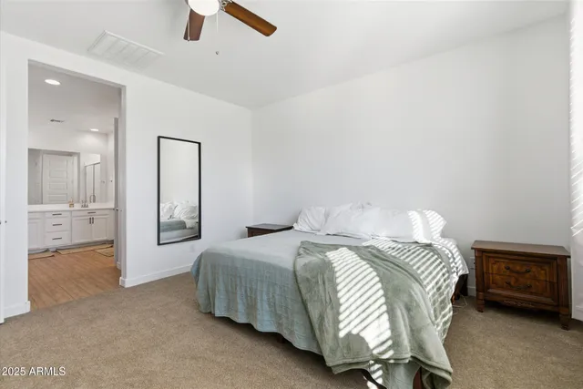 a living room with furniture and baby bed