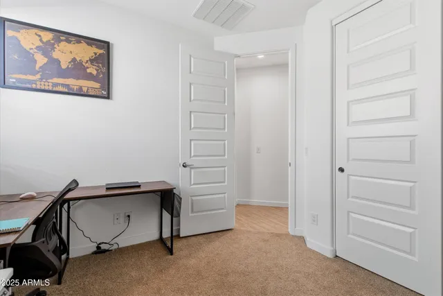 a bedroom with furniture and large windows