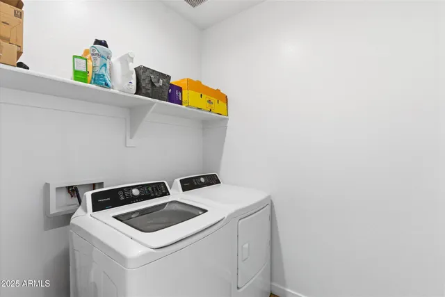 a view of a patio with table and chairs under an umbrella with a fire pit
