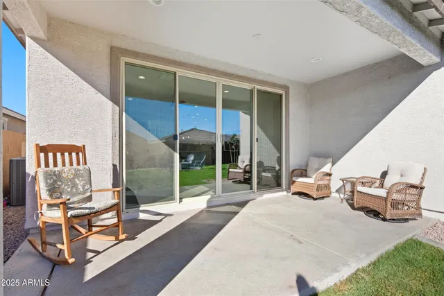 a view of a balcony with chairs and potted plants