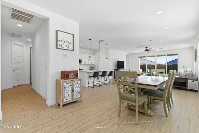 a dining room with furniture and wooden floor