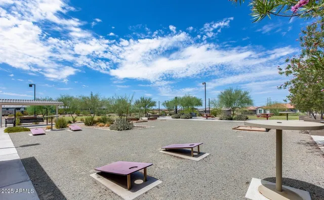 a view of a patio with couches and a table and chairs with wooden fence