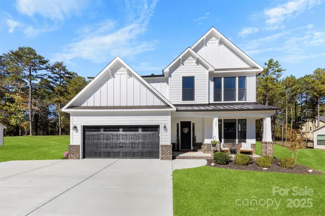a front view of a house with a yard and porch