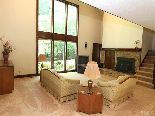 2713 Sherborne Place Raleigh, NC 27612 - Photo 2 of 25 Walk through the foyer with a wonderful skylight above, then walk into this fantastic great living room with cathedral ceilings stone fireplace with wood burning insert and floor to ceiling windows! Windows have been recently replaced. Living Room