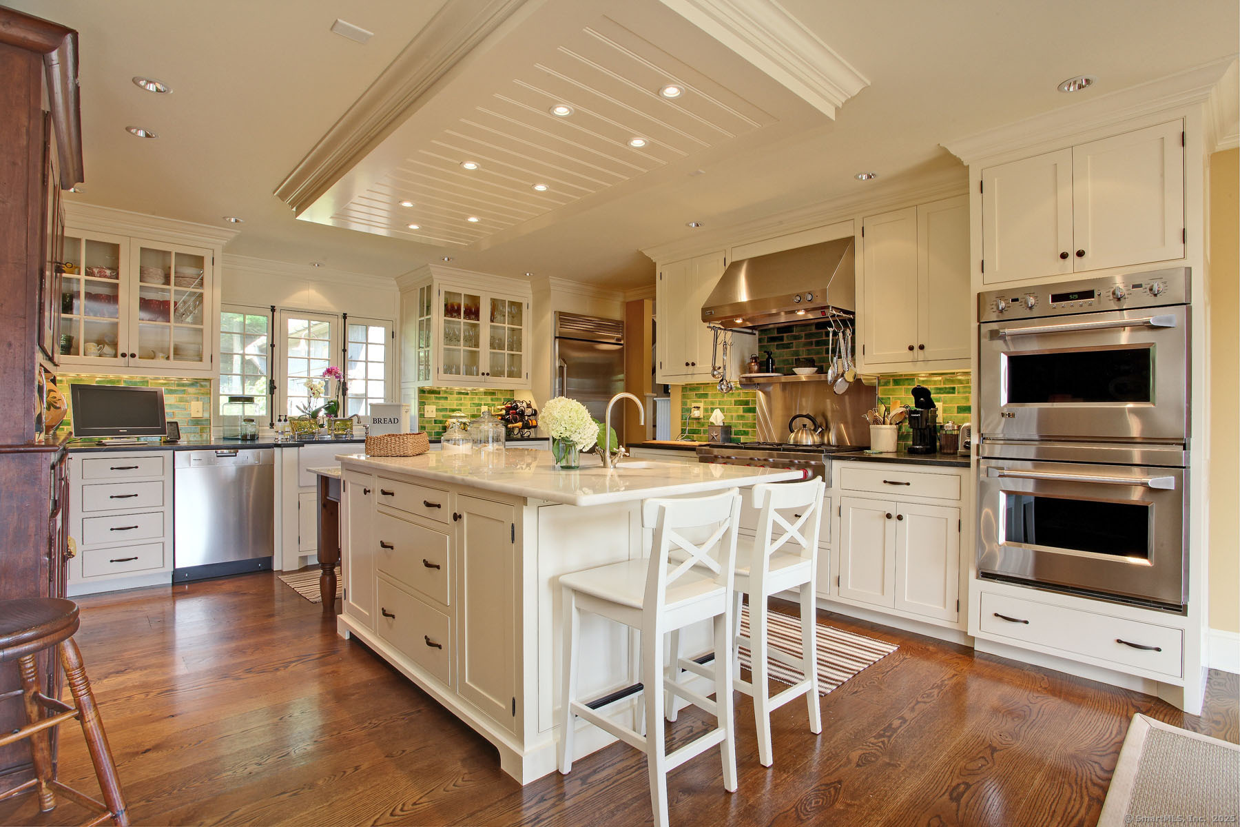 103 B Chalybes Road West Roxbury, CT 06783 - Photo 14 of 38 a kitchen with stainless steel appliances granite countertop a stove top oven a sink dishwasher and white cabinets with wooden floor