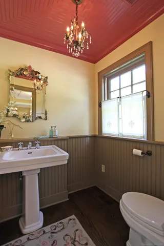 a bathroom with a sink a toilet and mirror