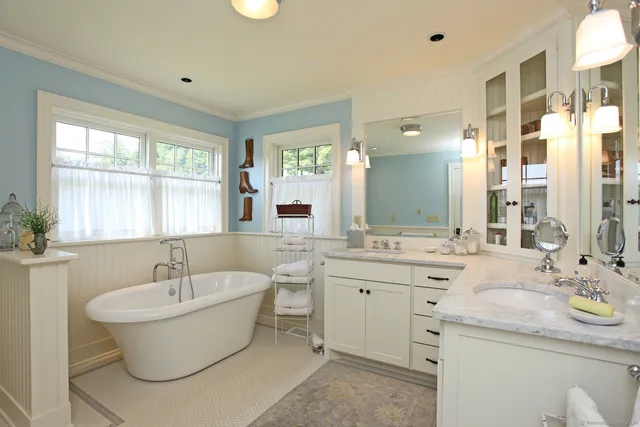a bathroom with a granite countertop sink and a bathtub