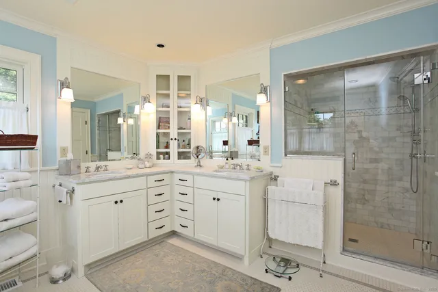 a spacious bathroom with a granite countertop sink mirror and shower