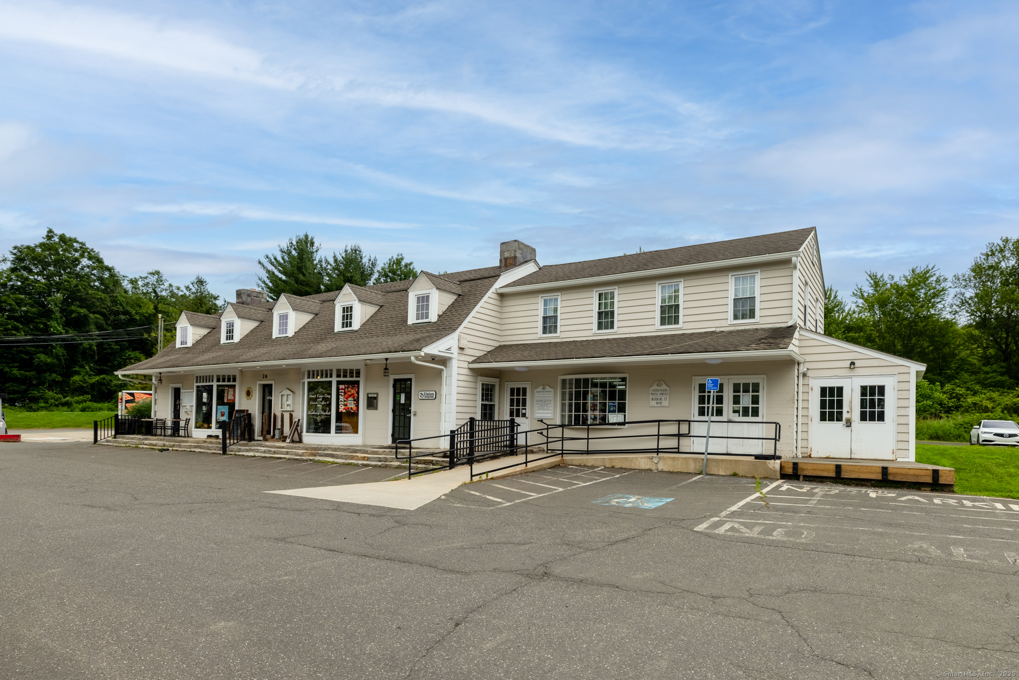 103 B Chalybes Road West Roxbury, CT 06783 - Photo 29 of 38 a front view of a building with lots of trees and plants