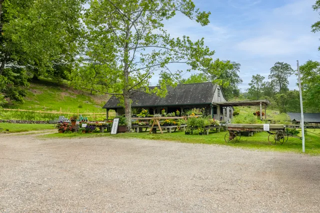 a view of a house with a yard and sitting area