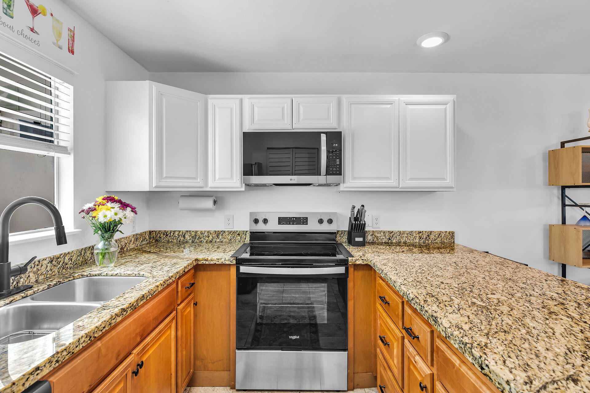 1075 Duval Street, Unit R10 Key West, FL 33040 - Photo 15 of 38 a kitchen with stainless steel appliances granite countertop a sink stove microwave and refrigerator