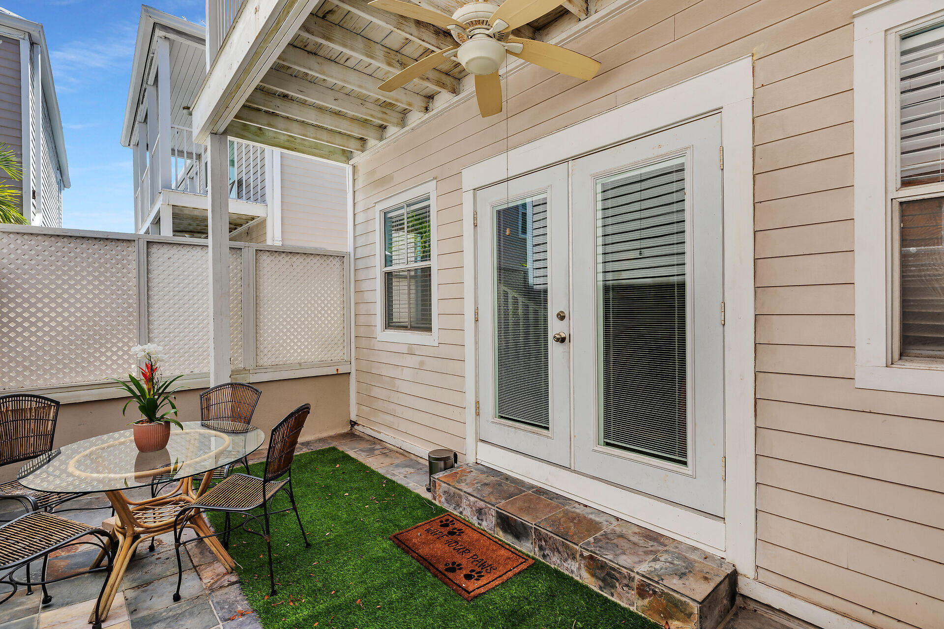 1075 Duval Street, Unit R10 Key West, FL 33040 - Photo 23 of 38 a backyard of a house with table and chairs