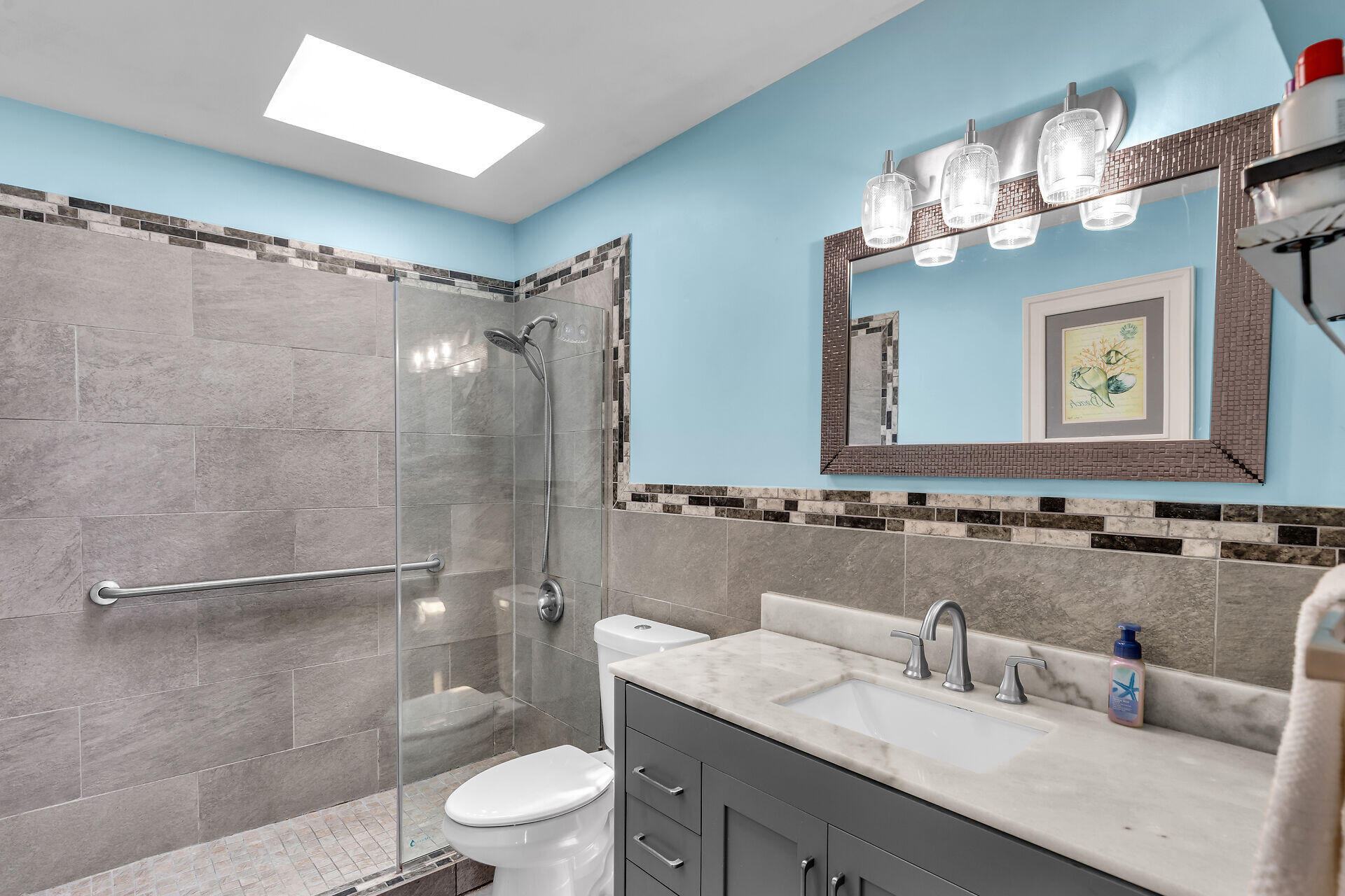 1075 Duval Street, Unit R10 Key West, FL 33040 - Photo 5 of 38 a bathroom with a double vanity sink mirror and toilet