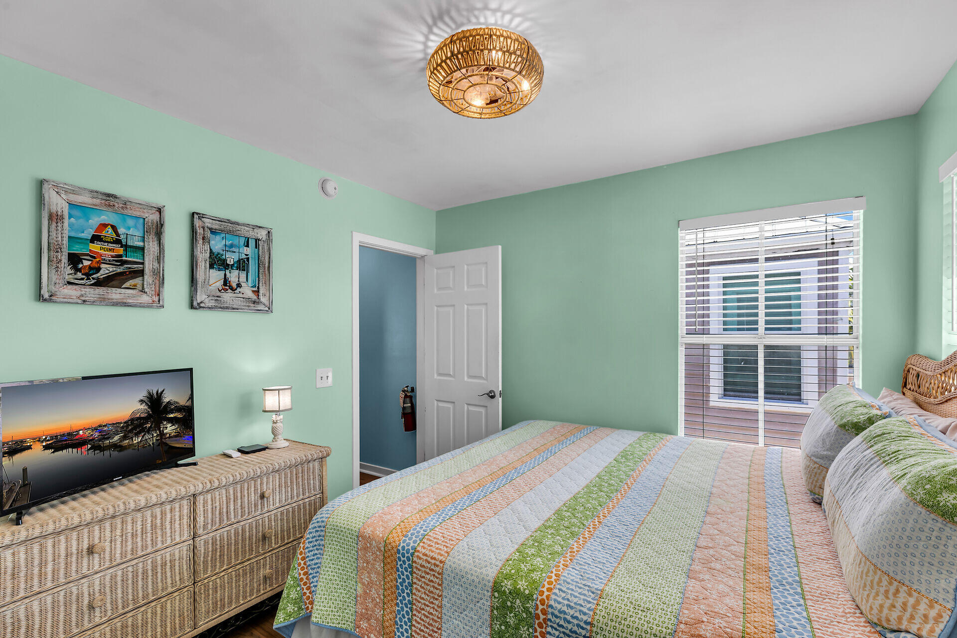 1075 Duval Street, Unit R10 Key West, FL 33040 - Photo 8 of 38 a bedroom with a bed and a window