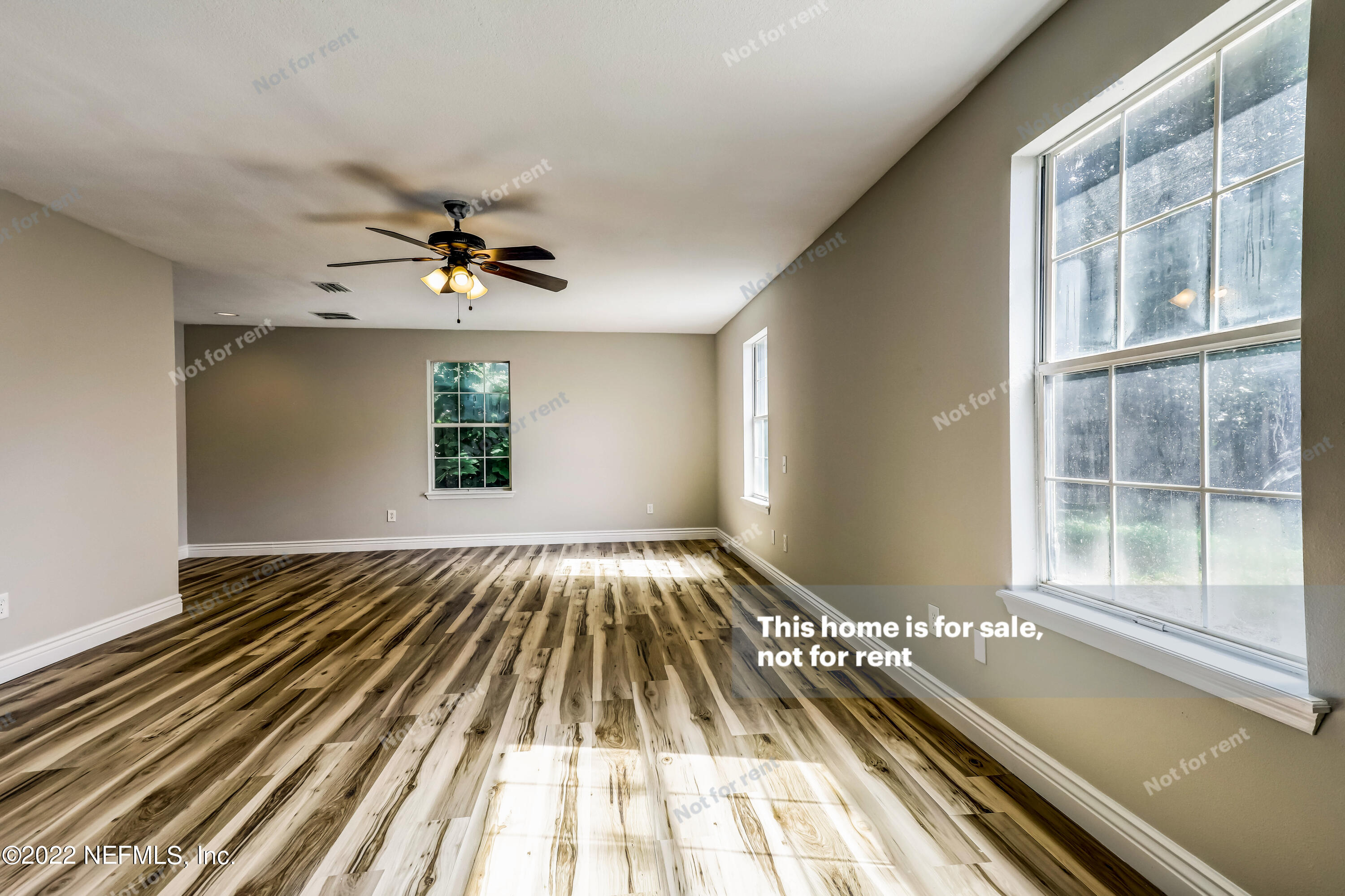 7403 Sandhurst Road South Jacksonville, FL 32277 - Photo 23 of 29 a view of a room with wooden floor and chandelier