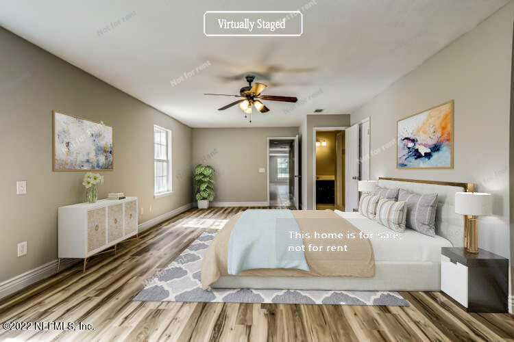 7403 Sandhurst Road South Jacksonville, FL 32277 - Photo 3 of 29 a spacious bedroom with a large bed a chandelier and dresser