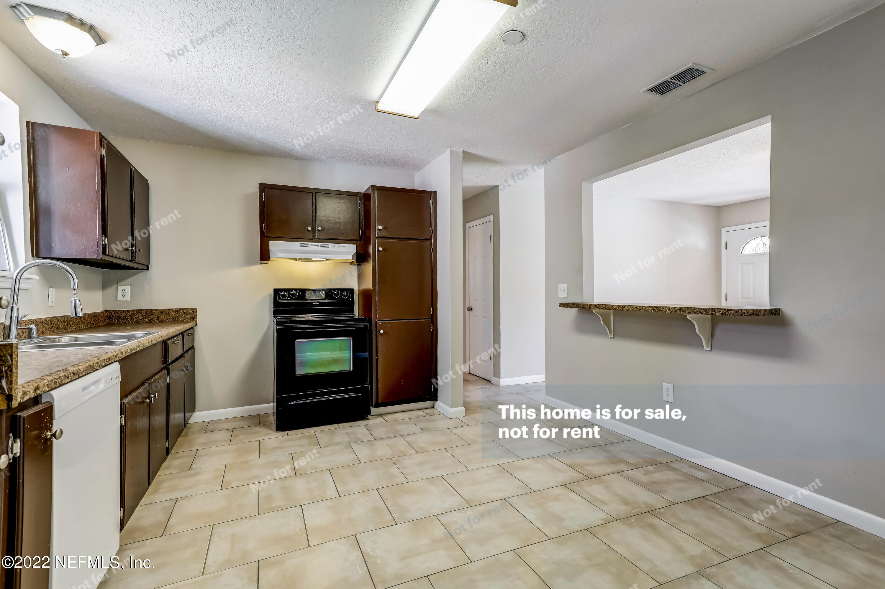 7403 Sandhurst Road South Jacksonville, FL 32277 - Photo 4 of 29 a kitchen with a stove a sink and a refrigerator