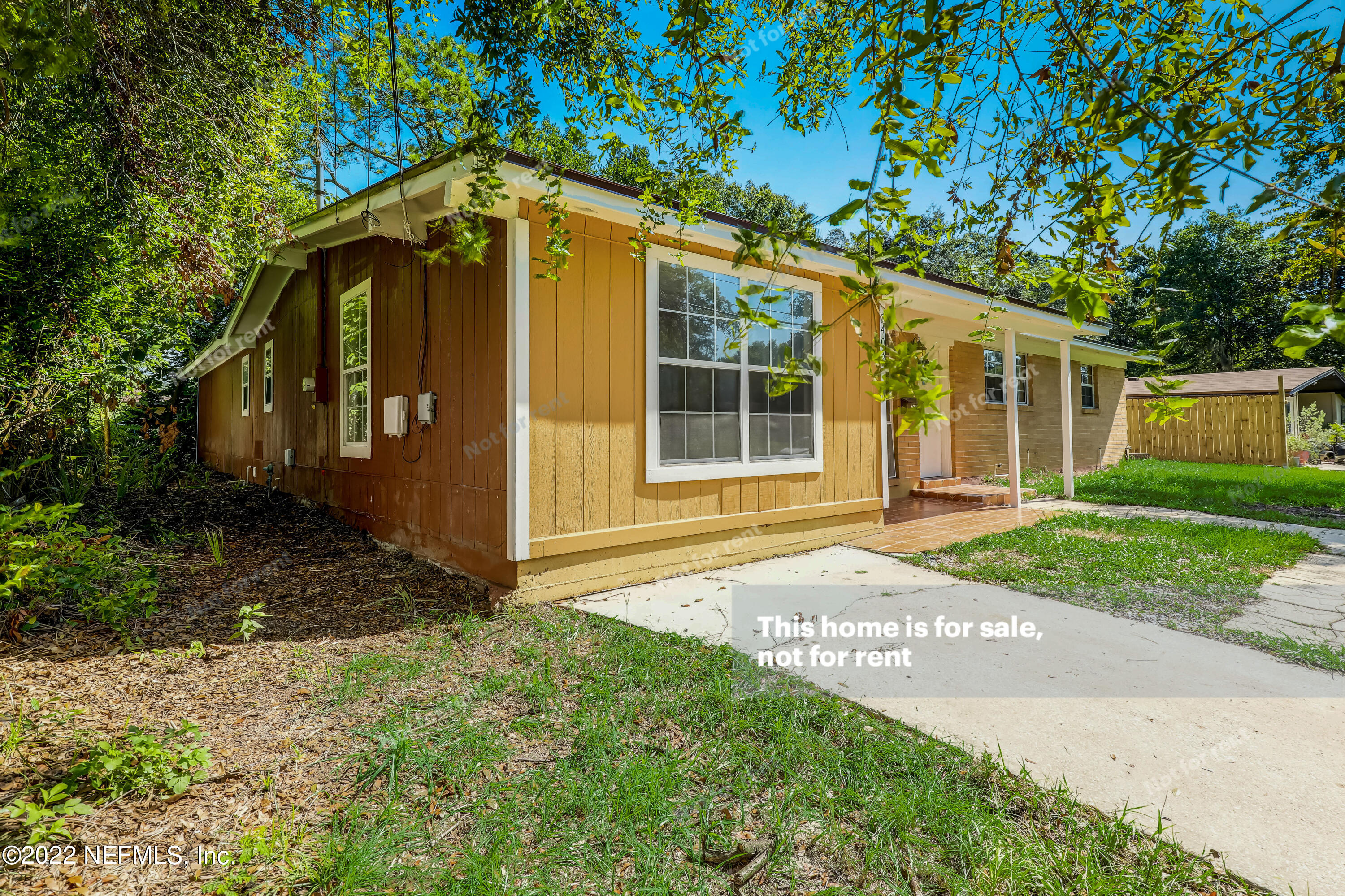 7403 Sandhurst Road South Jacksonville, FL 32277 - Photo 10 of 29 a front view of a house with a yard