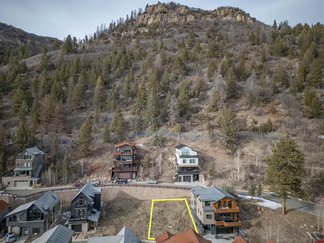 an aerial view of a house with mountain view