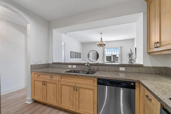 a kitchen with granite countertop a sink and cabinets