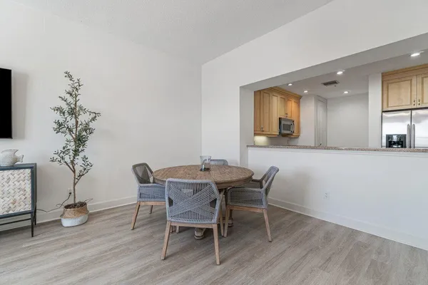 a view of a dining room with furniture and wooden floor