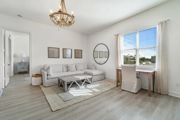 a living room with furniture a window and dining table