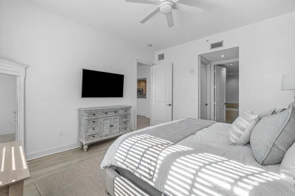 a bedroom with a bed and a flat screen tv