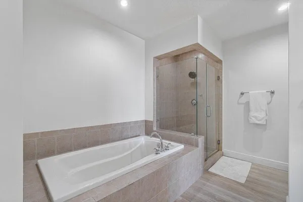 a spacious bathroom with a bathtub and shower