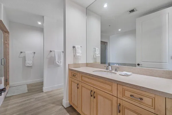 a spacious bathroom with a granite countertop sink mirror and double