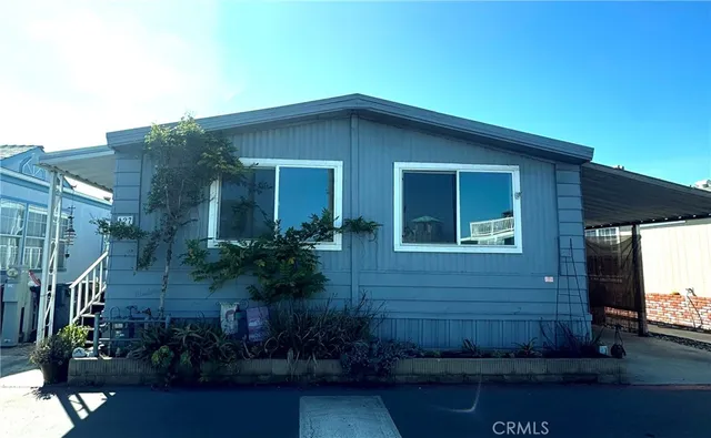 a view of house with yard and green space