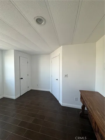 a view of an empty room and wooden floor