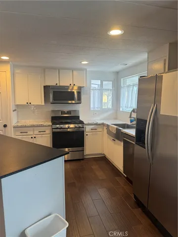a kitchen with cabinets and stainless steel appliances