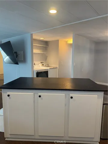 a kitchen with granite countertop a sink and a stove