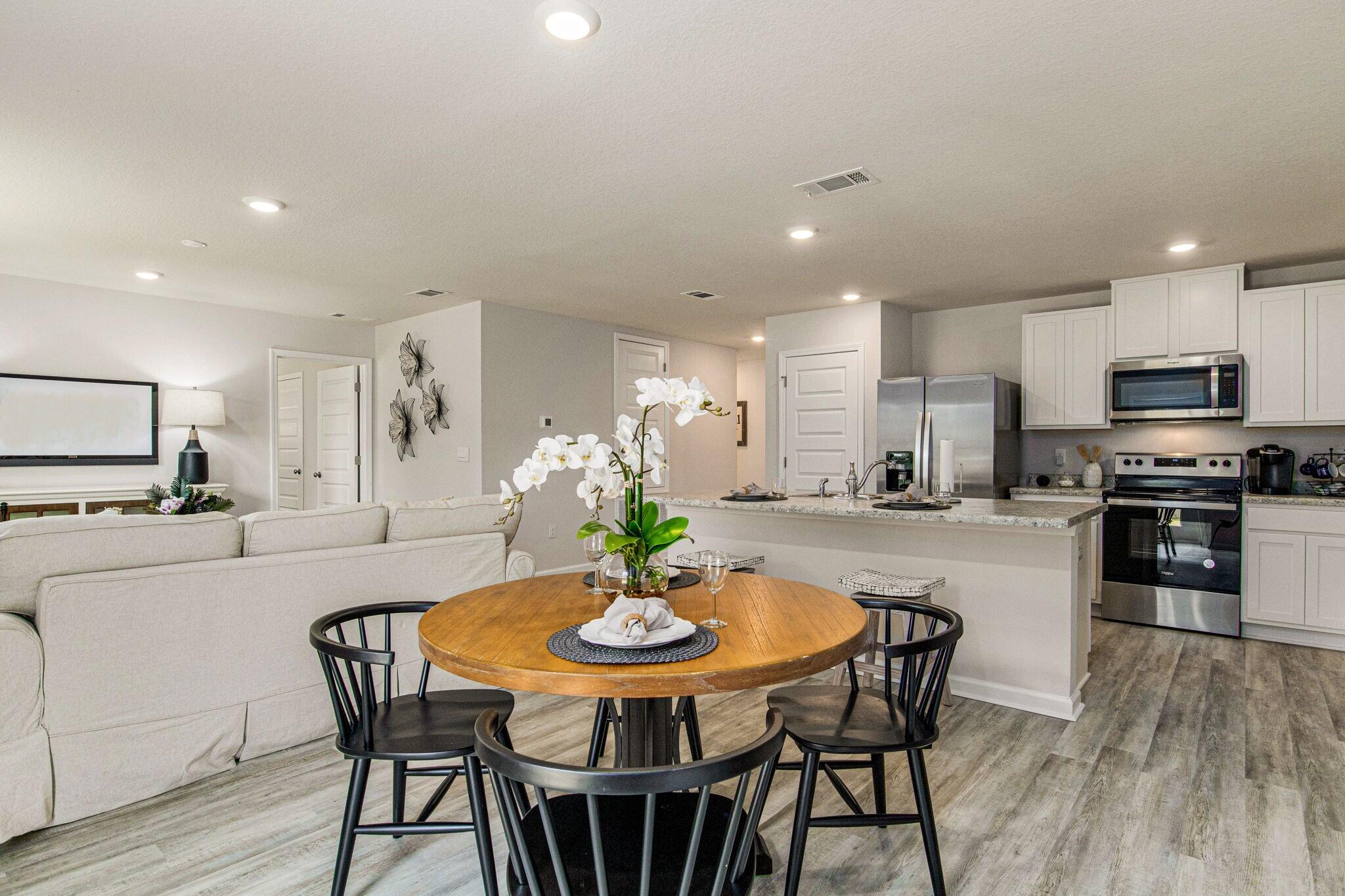 3064 Jane Lane Crestview, FL 32539 - Photo 5 of 33 a kitchen with a dining table chairs and refrigerator