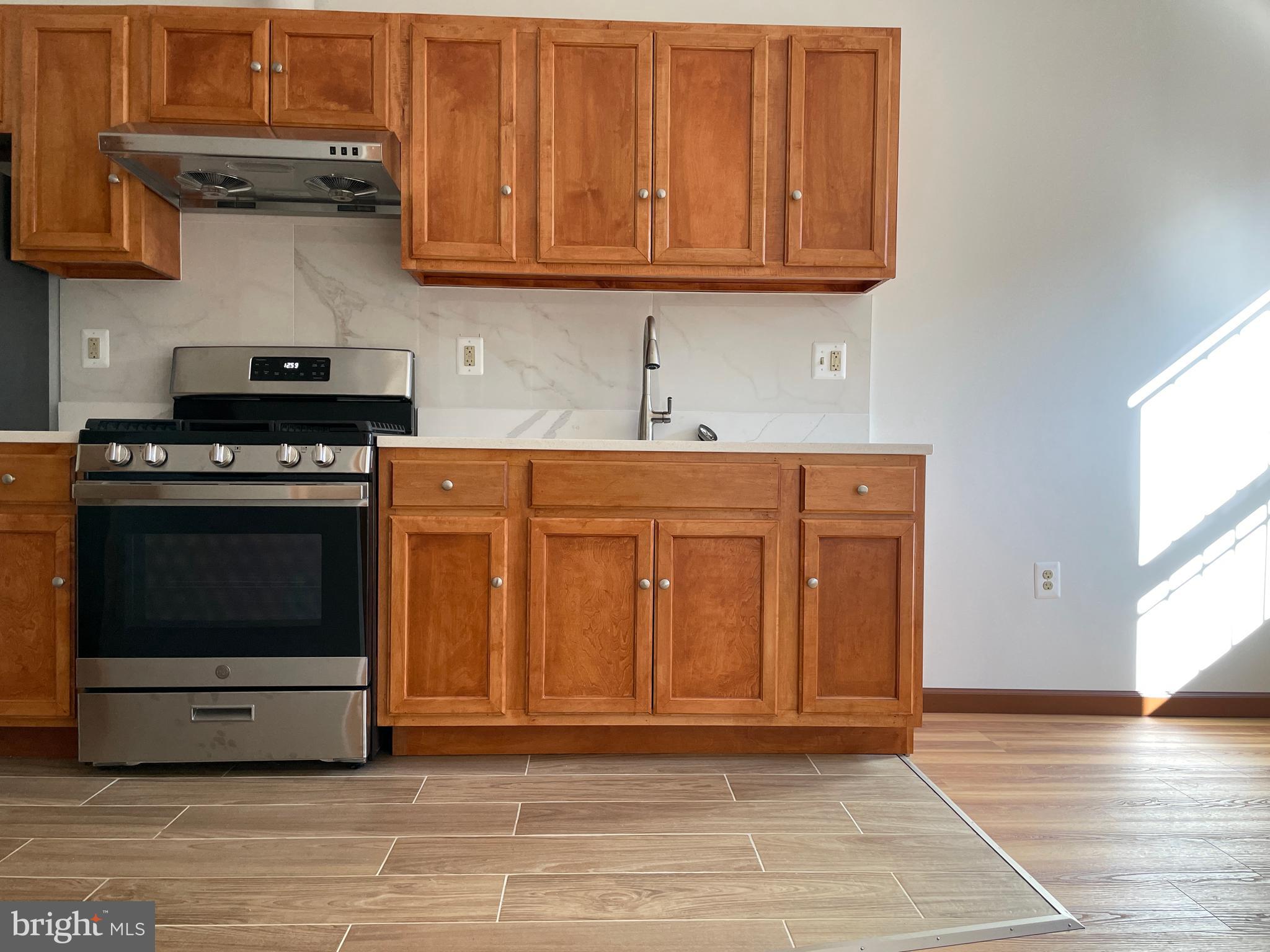 146 North 10th Street, Unit 3C Philadelphia, PA 19107 - Photo 14 of 14 a kitchen with stainless steel appliances granite countertop a stove and a cabinets