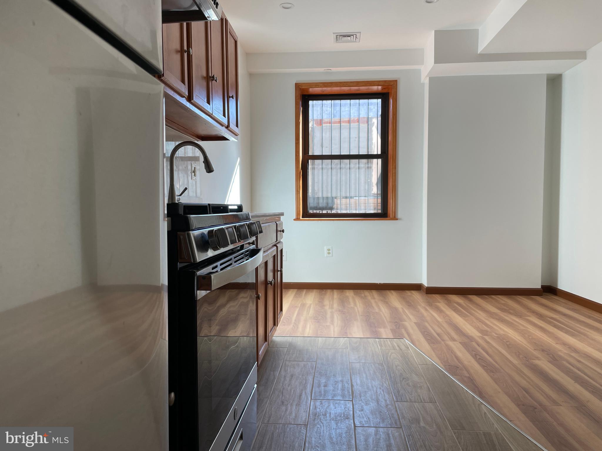146 North 10th Street, Unit 3C Philadelphia, PA 19107 - Photo 2 of 14 a view of a hallway with wooden floor and a window