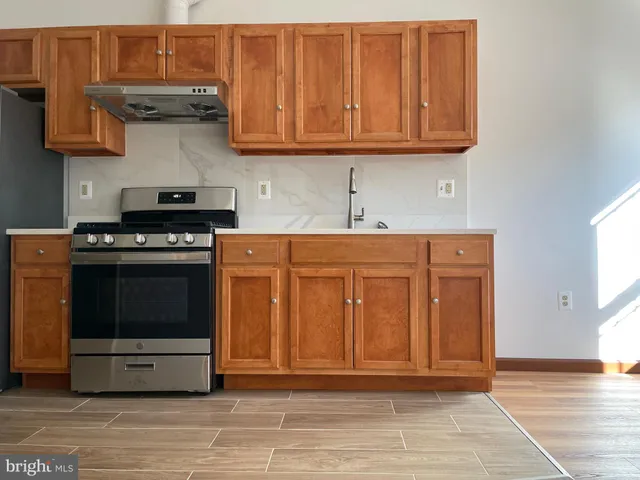 a kitchen with stainless steel appliances granite countertop a stove and a cabinets
