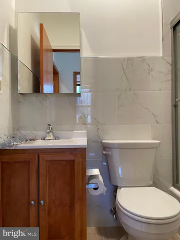 a white toilet sitting next to a bathroom sink