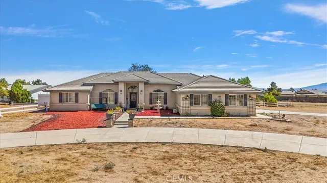 a view of a white house with a yard