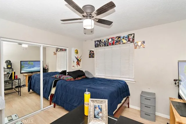 a bedroom with a bed and a chandelier