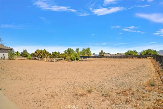 an aerial view of a house a yard and lake view