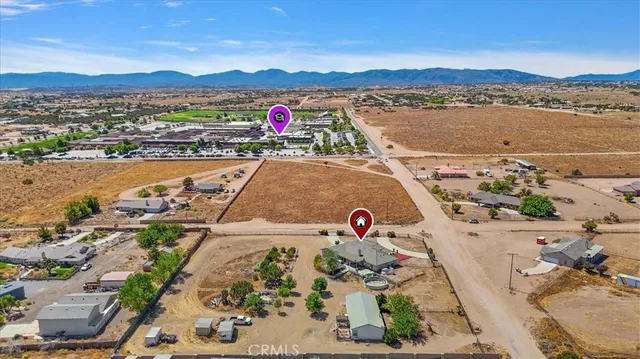 a view of a white house in front of a yard