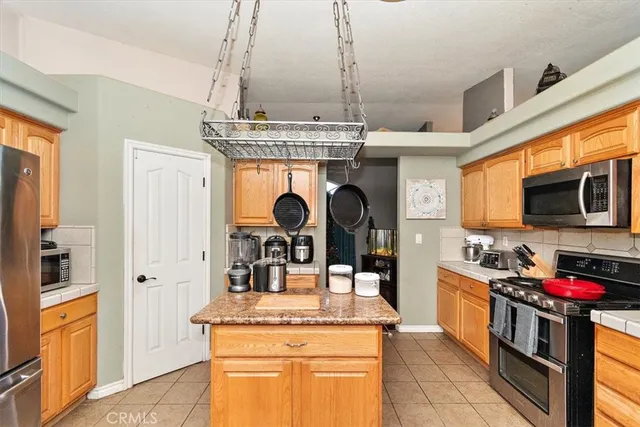 a kitchen with stainless steel appliances granite countertop a stove and cabinets